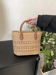 Detailed straw handbag with hollow diamond weave and brown leather handles for summer