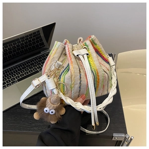 Colorful bohemian knitted bucket bag with drawstring closure and plush monster charm