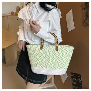 Close-up of woven tote bag featuring green checkered texture and natural bamboo handles