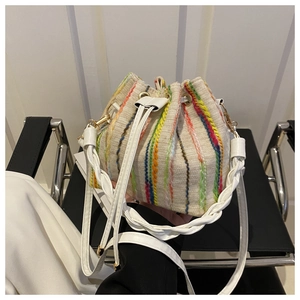 Bohemian canvas bucket bag with colorful vertical embroidery and gold metal accents