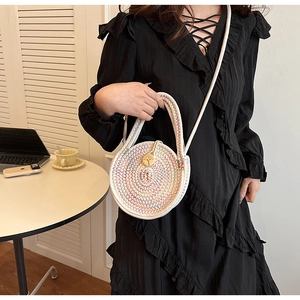 Detail of hand-woven round cotton linen crossbody bag with colorful spiral patterns