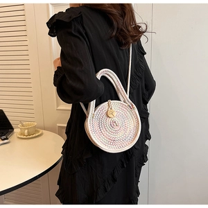 Detail of a round woven cotton linen crossbody bag with wooden button and rope handle