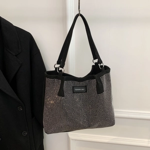 Detail of black rhinestone tote bag with silver metal rings and Fashion & Bag logo tag