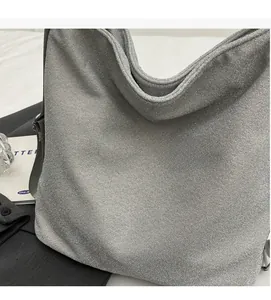 Detail of silver glitter PU fabric texture and shoulder strap on the large tote bag