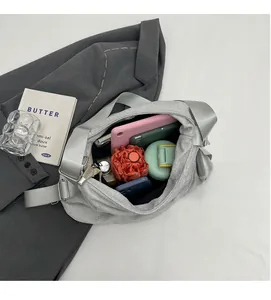 Top view of silver crescent bag interior showing capacity for phone, tablet and umbrella