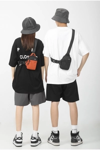 Dual models wearing waterproof nylon oxford chest bags with adjustable wide straps