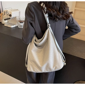 Close-up of sparkling silver hobo tote bag with shimmering fabric and metallic straps