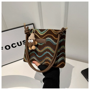 Brown boho knit crossbody bag with wave texture, leather strap and cute plush charm detail