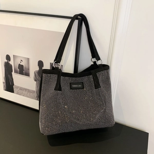 Chic black tote bag with shimmering silver rhinestones and fashion leather tag