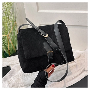 Spring 2024 minimalist black faux suede crossbody bag with metal buckle and adjustable strap