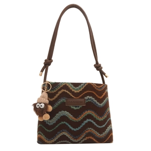 Brown crossbody bag with colorful wavy stripes, fashion leather label and plush monster charm