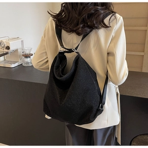 Detail of black hobo backpack in glitter PU fabric with adjustable fabric shoulder strap