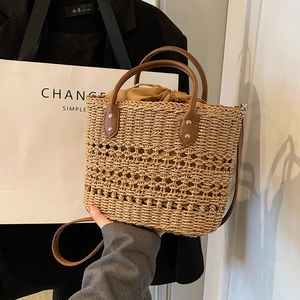 Bohemian woven straw handbag with brown PU leather strap and drawstring interior bag