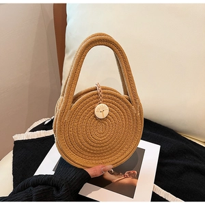 Handcrafted round woven cotton rope handbag in beige with natural shell button closure