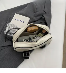 Detail view of the spacious inner compartment with fabric lining for the white PU handbag