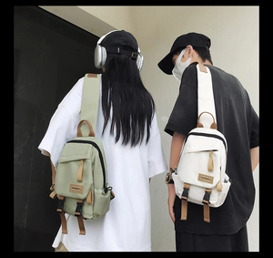 Detailed view of stylish nylon sling bags in light green and white for outdoor use