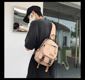 Detail of light beige nylon mini backpack with adjustable strap and buckle closure