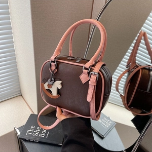Brown PU Boston bag with pink trim, wooden rocking horse charm and adjustable strap