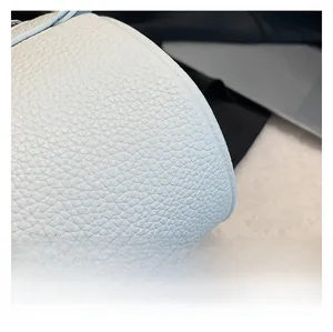 Close-up of premium light blue lychee pattern PU leather surface and fine stitching details