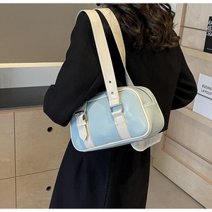Detail view of stylish light blue and cream PU shoulder bag with silver metal buckles