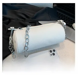 Detailed size comparison of white lychee leather cylinder bag with a smartphone