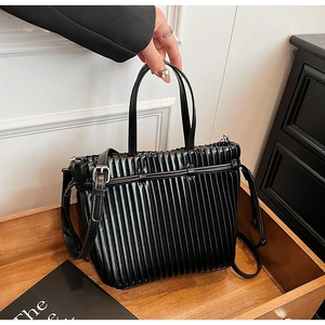 Chic black pleated faux leather handbag with silver hardware and adjustable shoulder strap