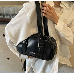 Detail of MoonShark black glossy PU leather shoulder bag with silver eyelet strap