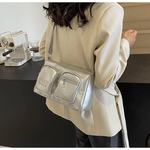 Detail of silver metallic PU crossbody bag with multi-pockets and adjustable strap