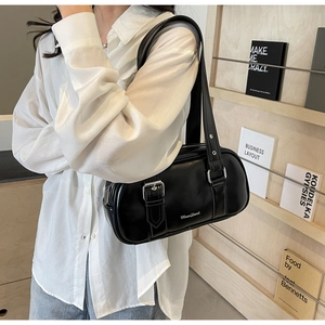 Side view of black PU leather barrel bag with silver buckle and MoonShark logo