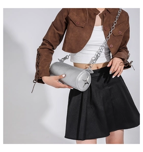 Close-up of silver cylinder crossbody bag with star detail and metal chain strap