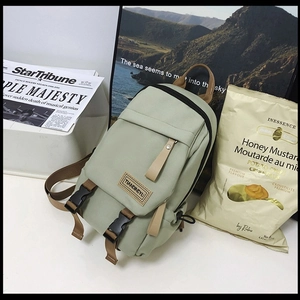 Mint green nylon backpack with brown straps and faux leather logo for casual daily use