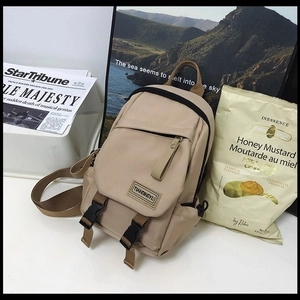 Minimalist khaki nylon backpack for women featuring stylish buckle straps and side pockets