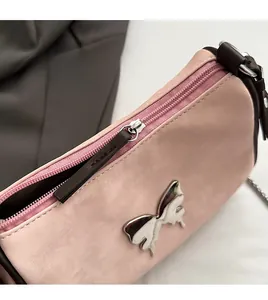 Détail de la fermeture éclair fluide et boucle papillon argentée sur sac PU rose