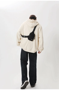 Detailed back view of a black nylon chest bag with an adjustable wide strap and buckle