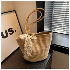 Handwoven rope bucket bag with elegant white lace bow decoration and shoulder strap