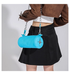 Detail of bright blue cylinder crossbody bag with silver star logo and metal chain