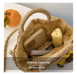 Macro view of woven straw bucket bag interior showing spacious capacity and drawstring lining