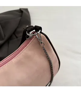 Détail du sac bandoulière en similicuir rose avec anneau en D argenté et fermoir mousqueton