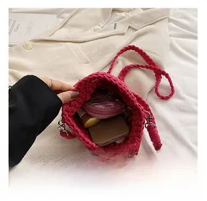 Macro shot of rose pink crochet bag interior holding smartphone and small purse