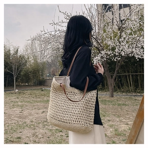 Detail of the hollow bohemian woven texture with sturdy brown leather handles