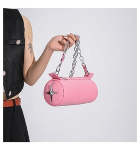 Detail of pink cylinder PU bag with silver star ornament and chunky metal chain strap