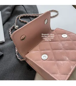 Detail of pink quilted PU shoulder bag featuring magnetic buckle closure and chain strap