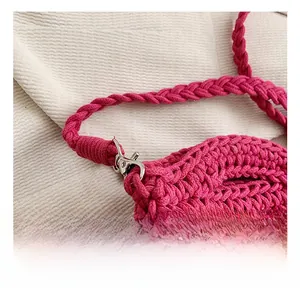 Detail of magenta knitted bag showing coarse texture and silver metal swivel hook