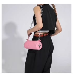 Pink cylinder pillow bag with lychee texture and silver star metallic details on shoulder