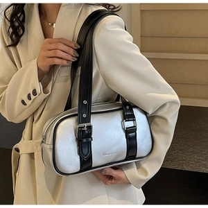 Detail of silver matte handbag with Moon Shark logo and adjustable black leather strap
