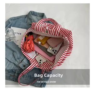 Internal view of a red striped canvas tote bag showing large capacity for daily items