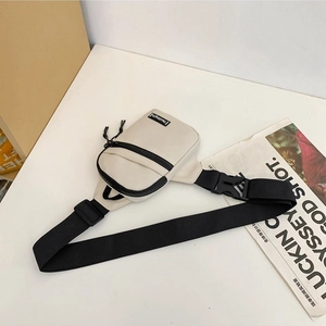 Minimalist cream nylon crossbody chest bag with black double zippers and wide shoulder strap