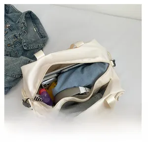 Top view of large cream canvas tote bag showing interior storage for laptop and gear
