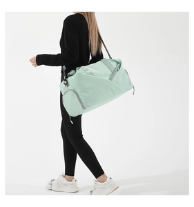 Detail view of light green multi-functional sports gym bag with adjustable shoulder straps