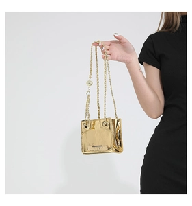 Detail of mirror gold mini shoulder bag with metallic finish and gold woven chain strap